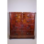 A Victorian figured mahogany chest of two over three drawers with rounded corners, raised on bun