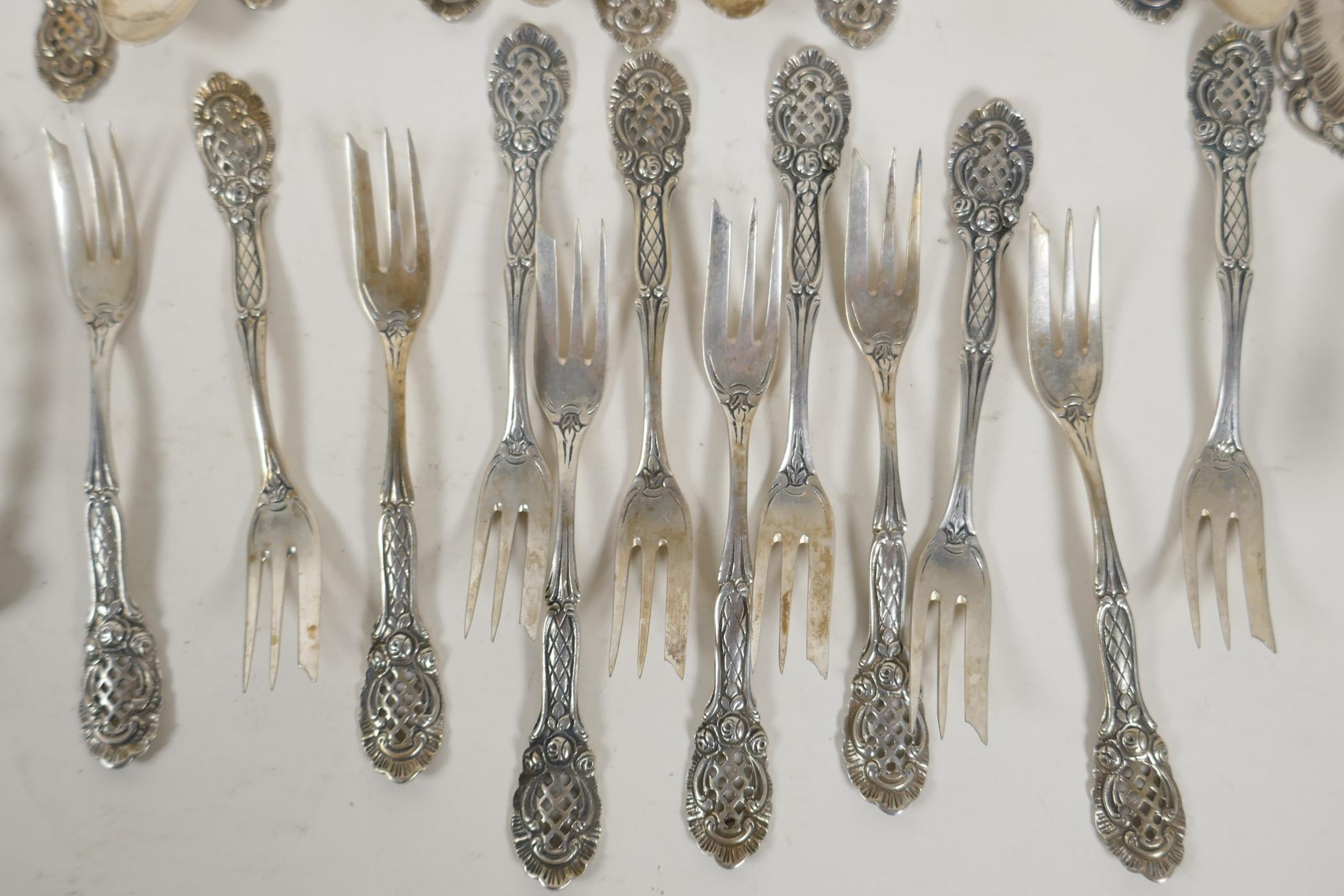 A set of twelve continental silver (800 mk) cake forks with pierced handles, and a set of twelve - Image 2 of 5