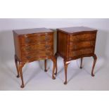 A pair of walnut serpentine bedside chests, raised on cabriole supports, 20" x 14", 30" high