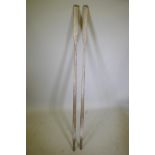 A pair of painted and distressed row boat oars, 96" long