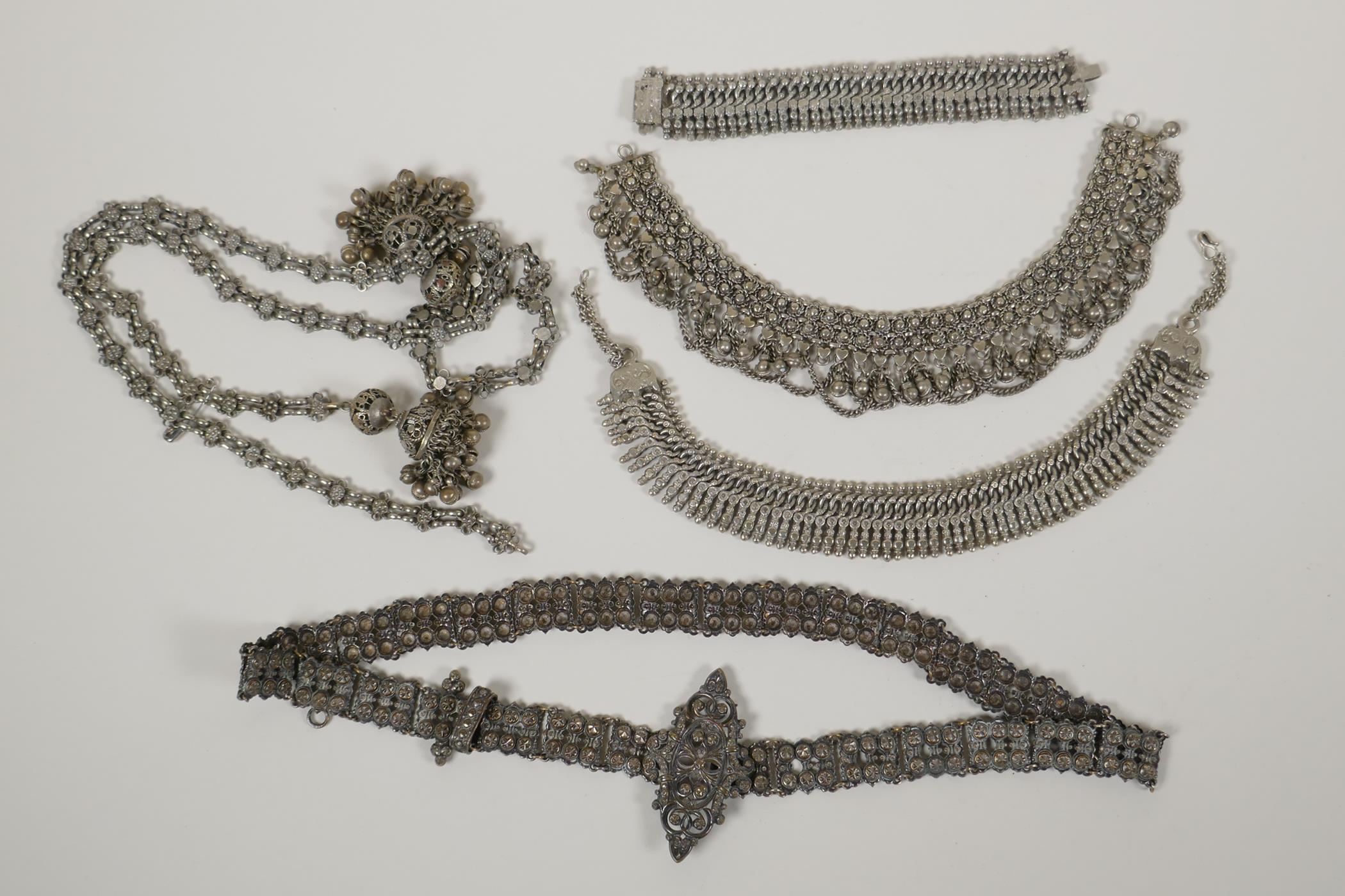 A collection of Indian white metal jewellery including bracelets, necklaces and belts