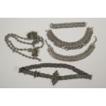 A collection of Indian white metal jewellery including bracelets, necklaces and belts