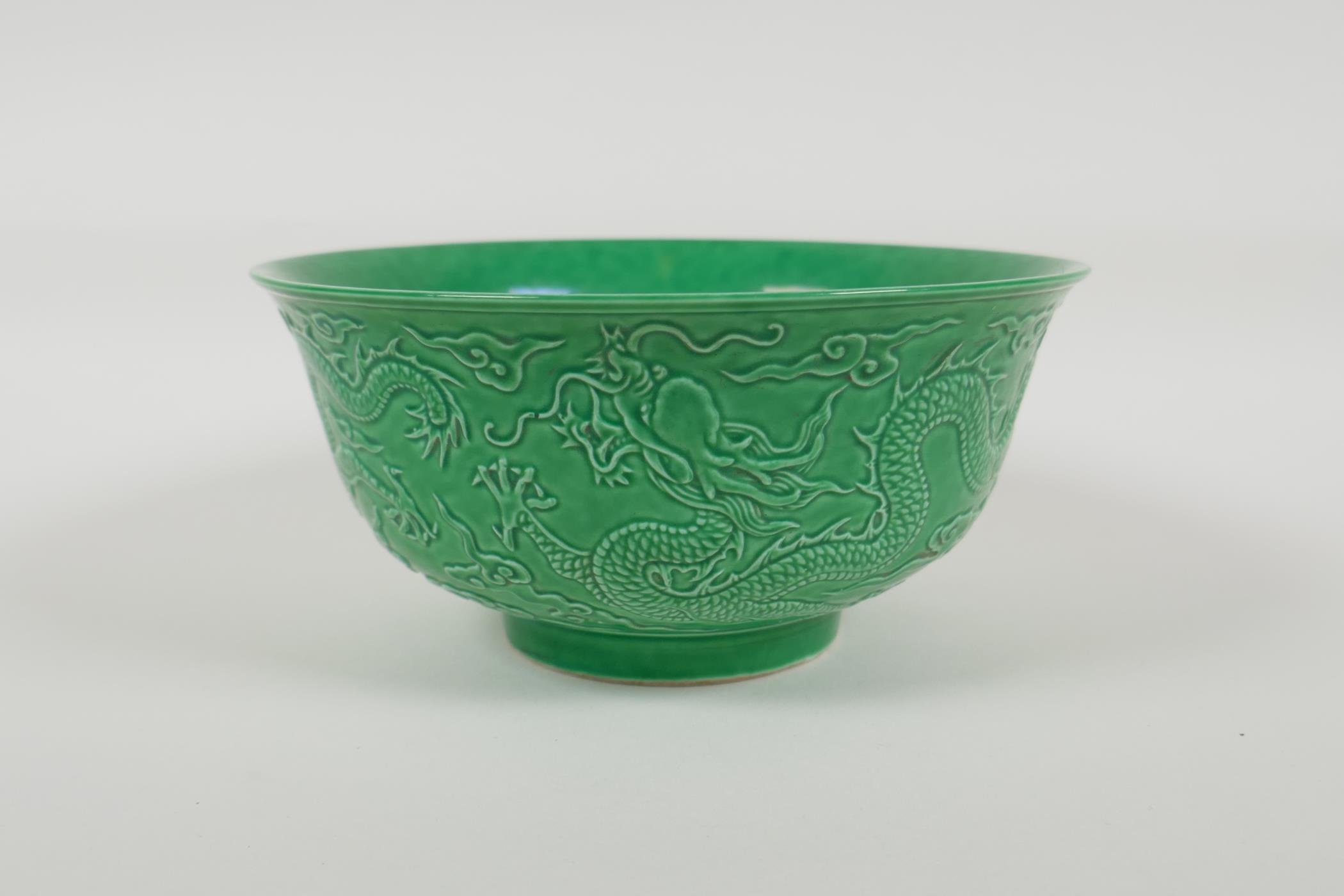 A green glazed porcelain rice bowl with raised dragon decoration, Chinese Yongzheng 6 character mark