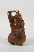 A Chinese carved boxwood figure of an immortal riding a three legged toad, 5½" high