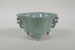 A Chinese celadon glazed Ru ware style censer with two handles and tripod supports, 2½" high