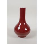 A Chinese sang de boeuf glazed porcelain bottle vase, 7" high