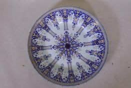 A large antique continental faience charger, marked BK to base, 24" diameter