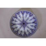 A large antique continental faience charger, marked BK to base, 24" diameter