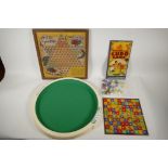 A collection of vintage board games and associated tokens and dice, including Ludo, Snakes and