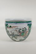 A famille vert porcelain jardiniere with decorative panels depicting figures in gardens and birds