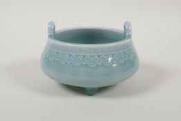 A Chinese baby blue glazed two handled porcelain censer raised on tripod supports, impressed seal