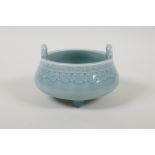 A Chinese baby blue glazed two handled porcelain censer raised on tripod supports, impressed seal