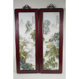 A pair of Chinese famille vert porcelain panels depicting riverside landscapes, in hardwood