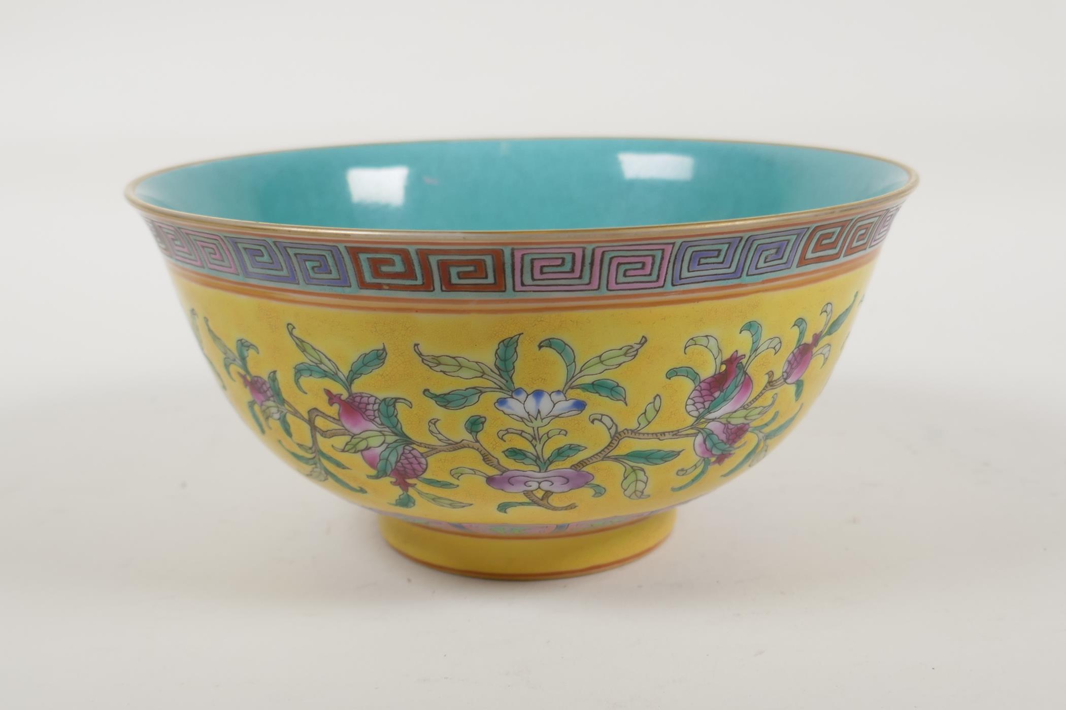 A Chinese yellow and turquoise ground porcelain rice bowl with famille rose enamelled peach tree