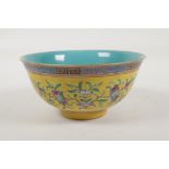 A Chinese yellow and turquoise ground porcelain rice bowl with famille rose enamelled peach tree