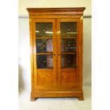 A C19th Continental Biedermeier style fruitwood armoire, with ebony stringing, the doors later