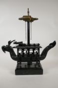 A Chinese ebonised hardwood table lamp in the form of a dragon boat, A/F losses, 18½" high