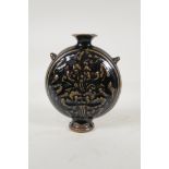 A Chinese Cizhou kiln flask with two lug handles and raised floral decoration, 8½" high