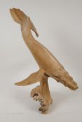 A carved driftwood figure of a humpback whale, 14" high