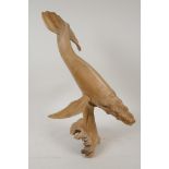 A carved driftwood figure of a humpback whale, 14" high