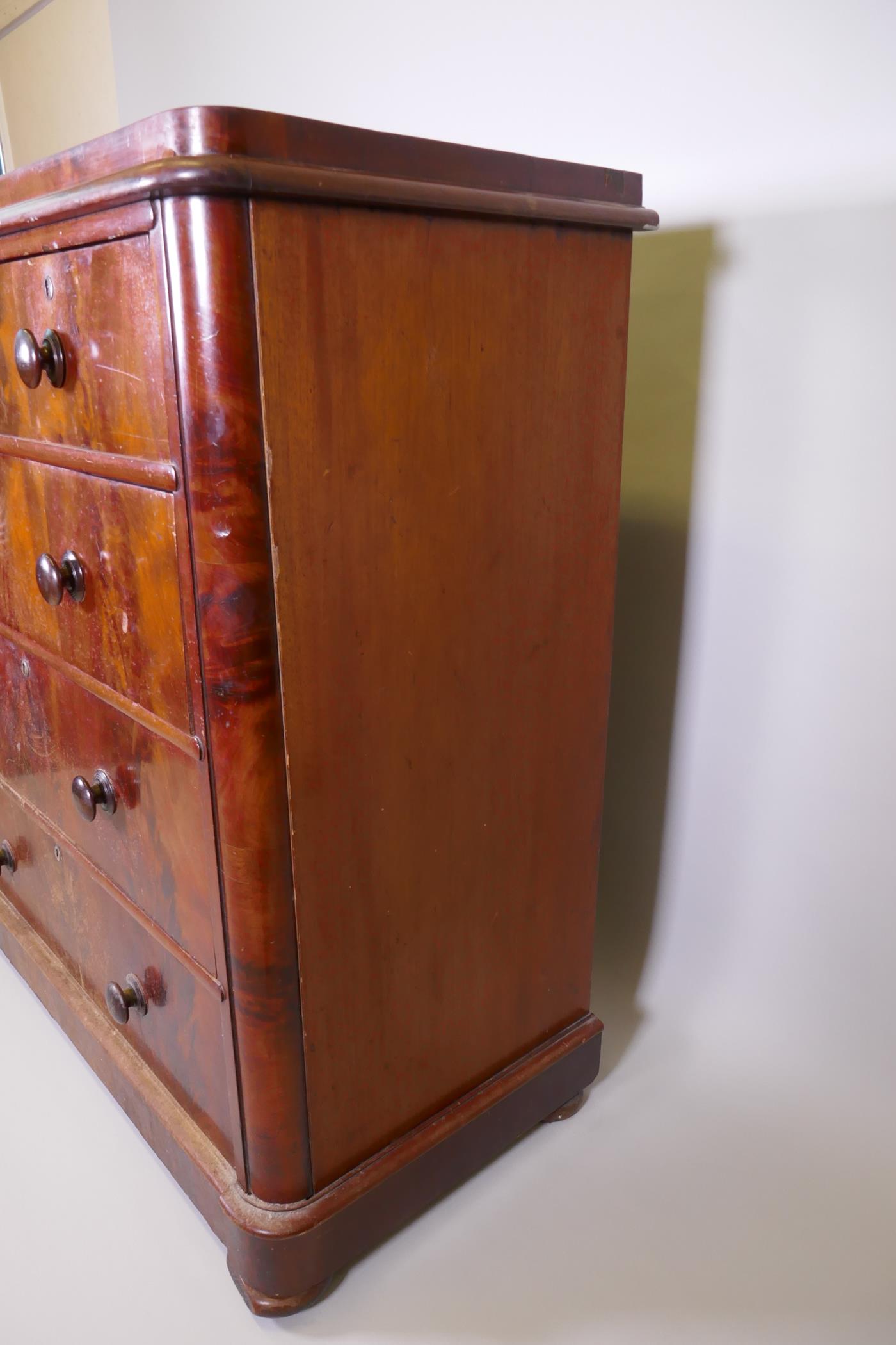 A Victorian figured mahogany chest of two over three drawers with rounded corners, raised on bun - Image 5 of 5