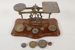 A set of brass and mahogany postal scales with two sets of weights, 9" long