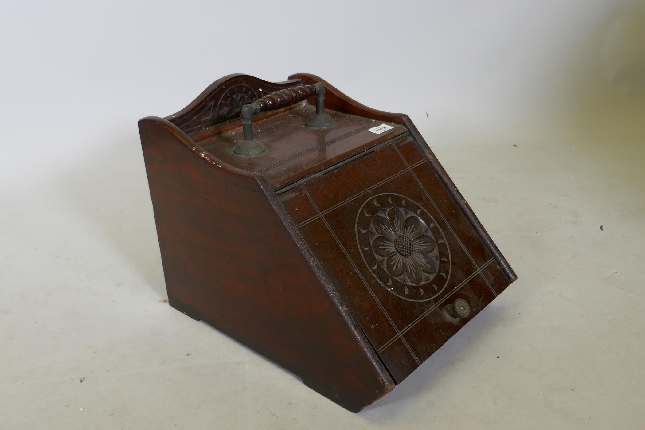 A Victorian mahogany and brass mounted coal scuttle with carved decoration, 18" x 13" x 13"