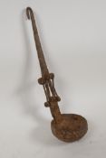 An antique Indian riveted metal oil ladle, 12" long