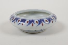 A blue and white porcelain dish with a rolled rim, red highlighted carp decoration, and Chinese 4