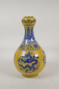 A Ming style yellow ground porcelain garlic head shaped vase with blue and white dragon