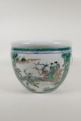 A famille verte porcelain jardiniere with decorative panels depicting figures in gardens and birds