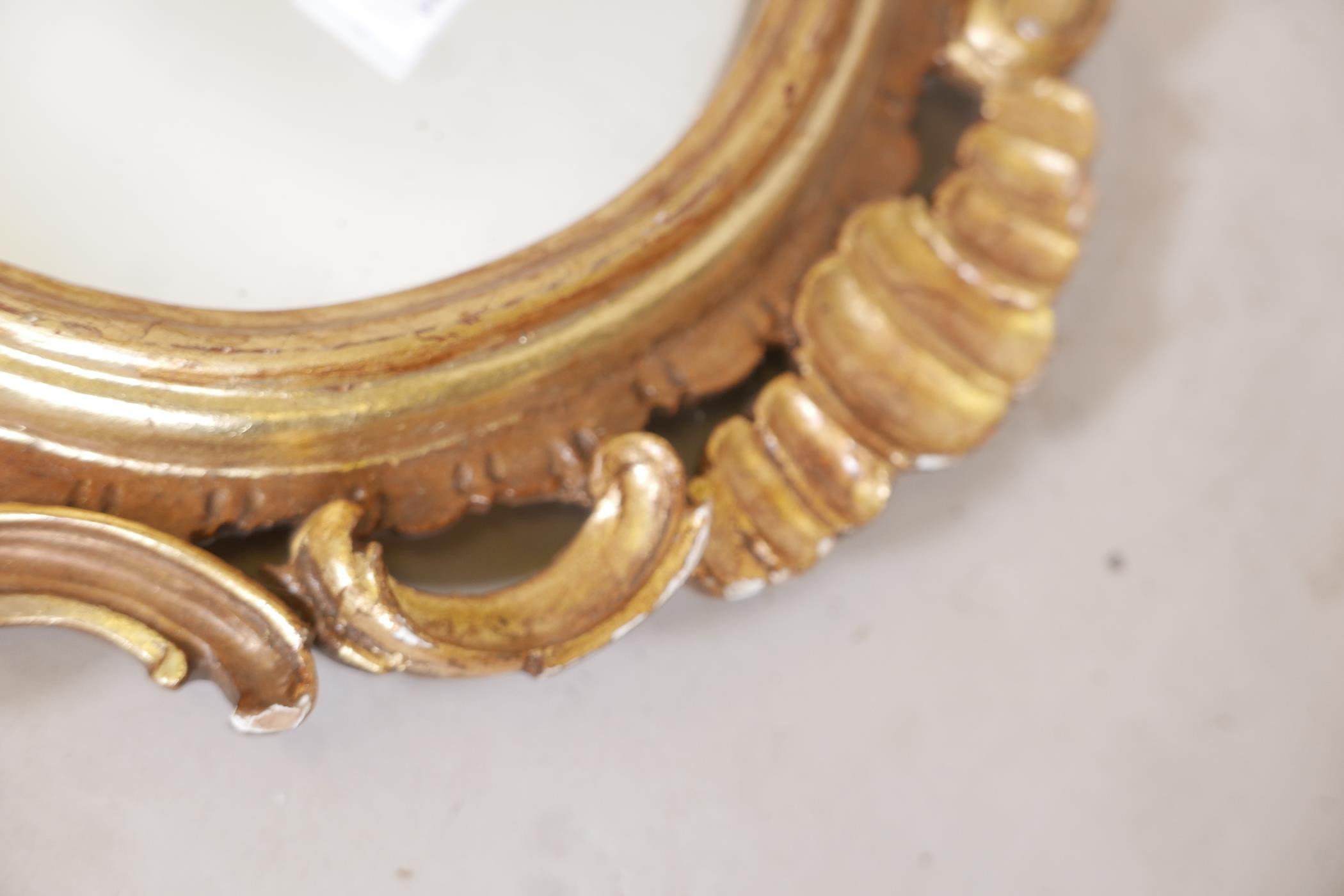 A carved and pierced giltwood rococo style wall mirror, early C20th, 35" long - Image 3 of 4