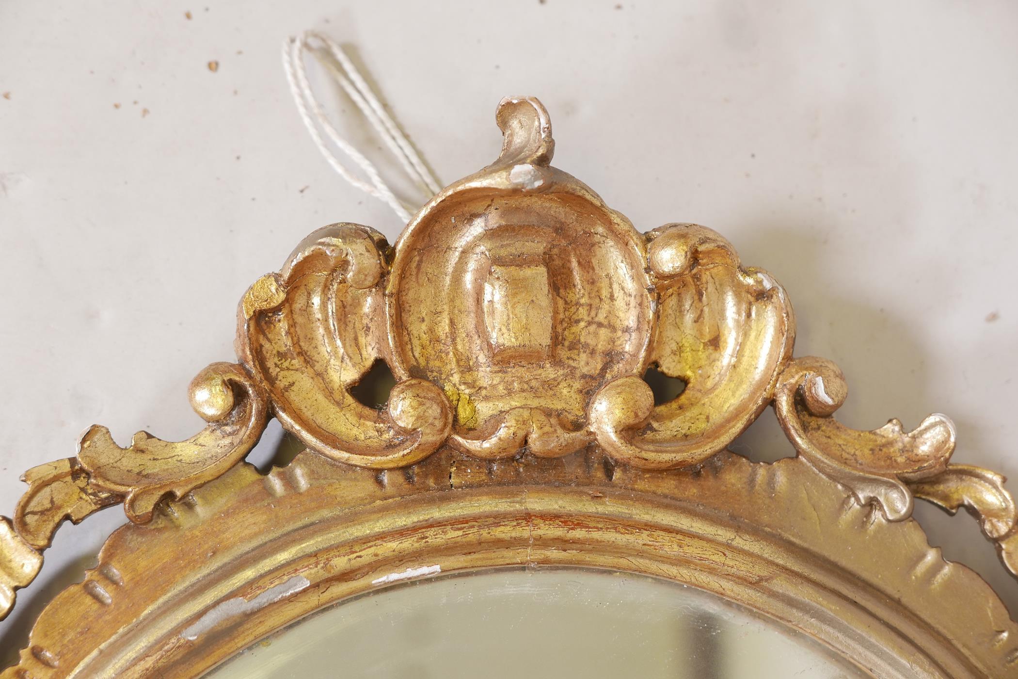 A carved and pierced giltwood rococo style wall mirror, early C20th, 35" long - Image 2 of 4