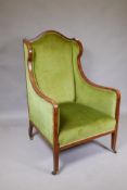 A Victorian mahogany wingback armchair with green upholstery