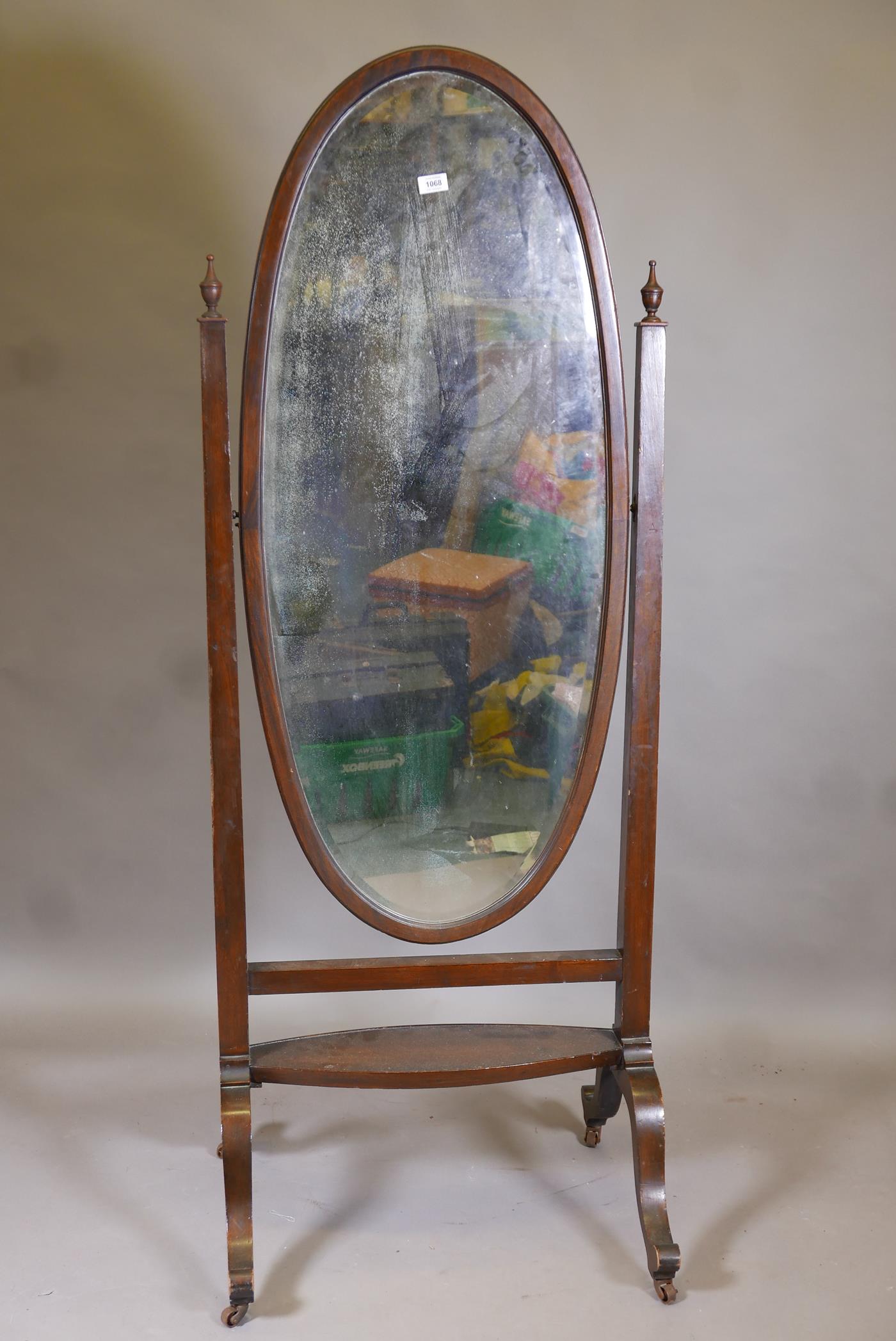 A Victorian mahogany cheval mirror with original bevelled glass, raised on cabriole supports with