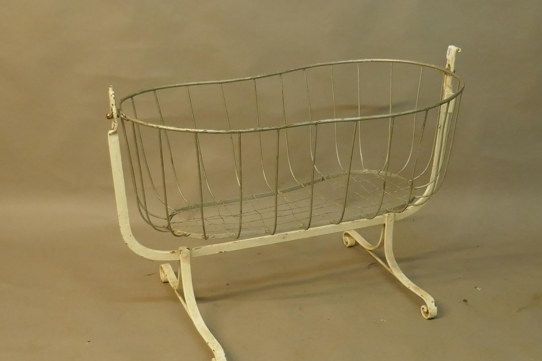 A Victorian painted wrought iron cradle, 40" x 22", 29" high