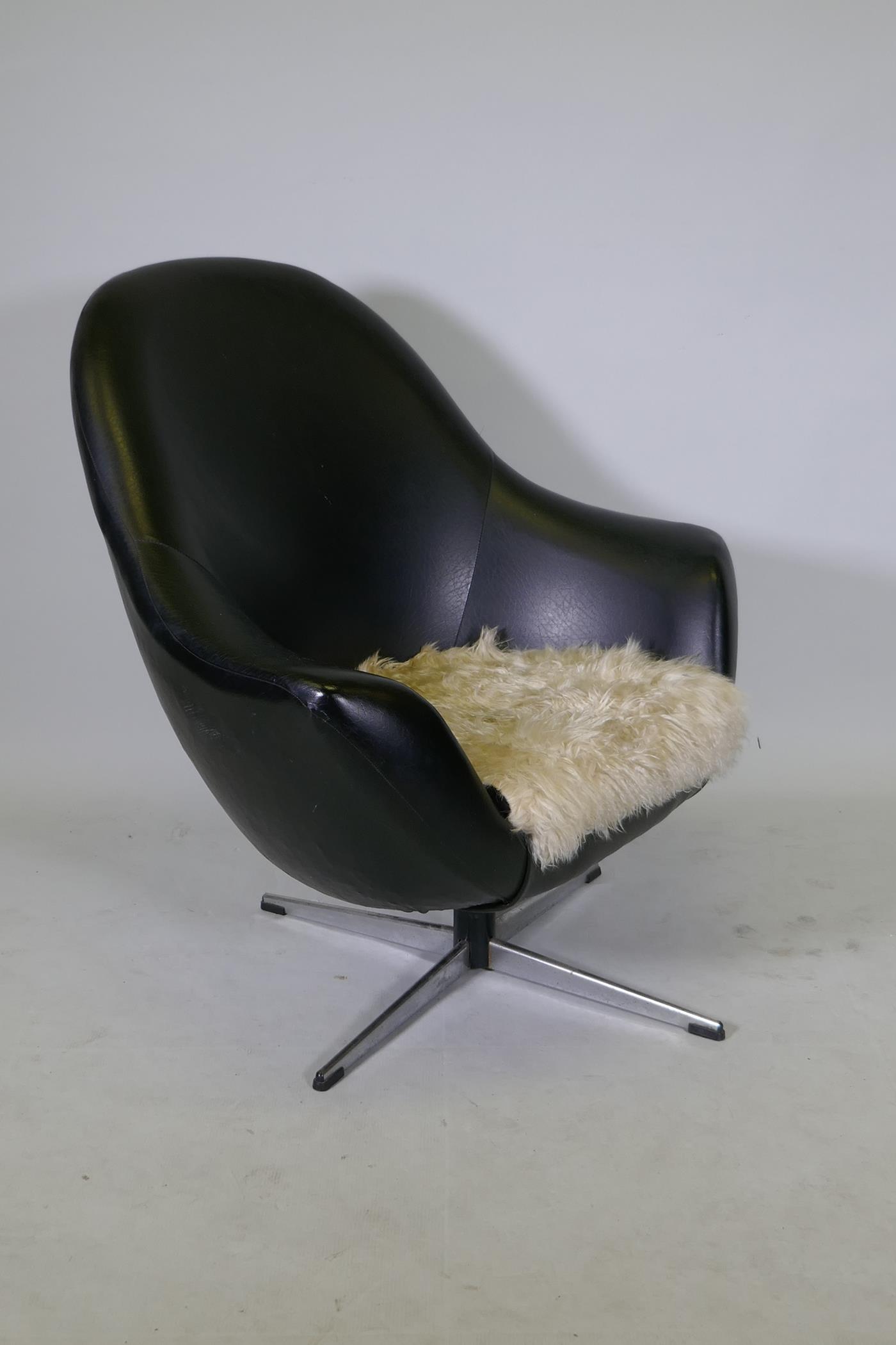 A 1970s leatherette and chrome swivel armchair