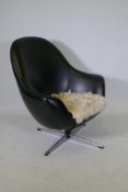 A 1970s leatherette and chrome swivel armchair