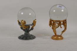 A glass ball mounted gilt metal base and another similar, 8" high