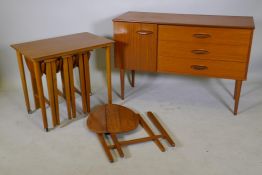 A 1970s teak side cabinet with three drawers and cupboard, and a nest of circular topped