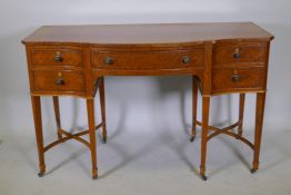 A C19th satinwood five drawer kneehole desk, with serpentine front and canted corners, raised on