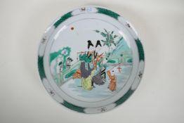 A famille vert porcelain charger decorated with women and children in a garden, Chinese KangXi 6