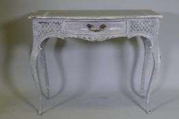 A serpentine front single drawer side table with carved and painted decoration, 36" x 19" x 29"