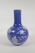 A blue glazed porcelain vase with white enamelled floral decoration, Chinese Qianlong seal mark to