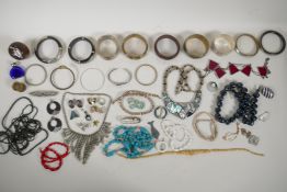 A quantity of vintage costume jewellery, mostly bangles and necklaces, including a sterling silver