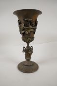 A cast iron vase decorated with fruiting vines, 11" high