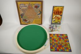 A collection of vintage board games and associated tokens and dice, including Ludo, Snakes and