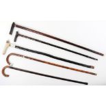 Five walking sticks, including a rosewood and banded stick