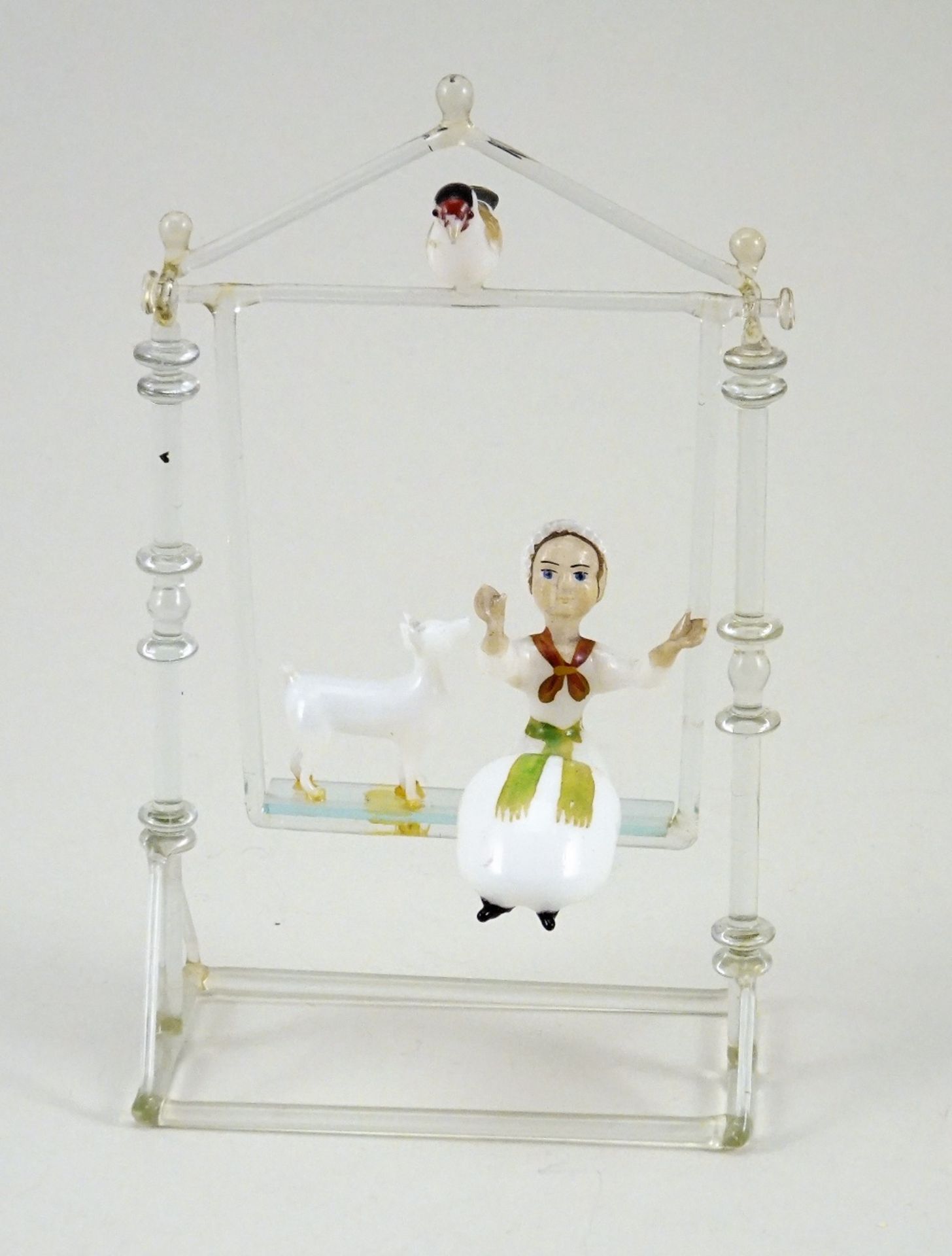 A blown glass Swing with Girl and Dog