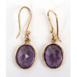 A pair of gold and amethyst drop pendant earrings